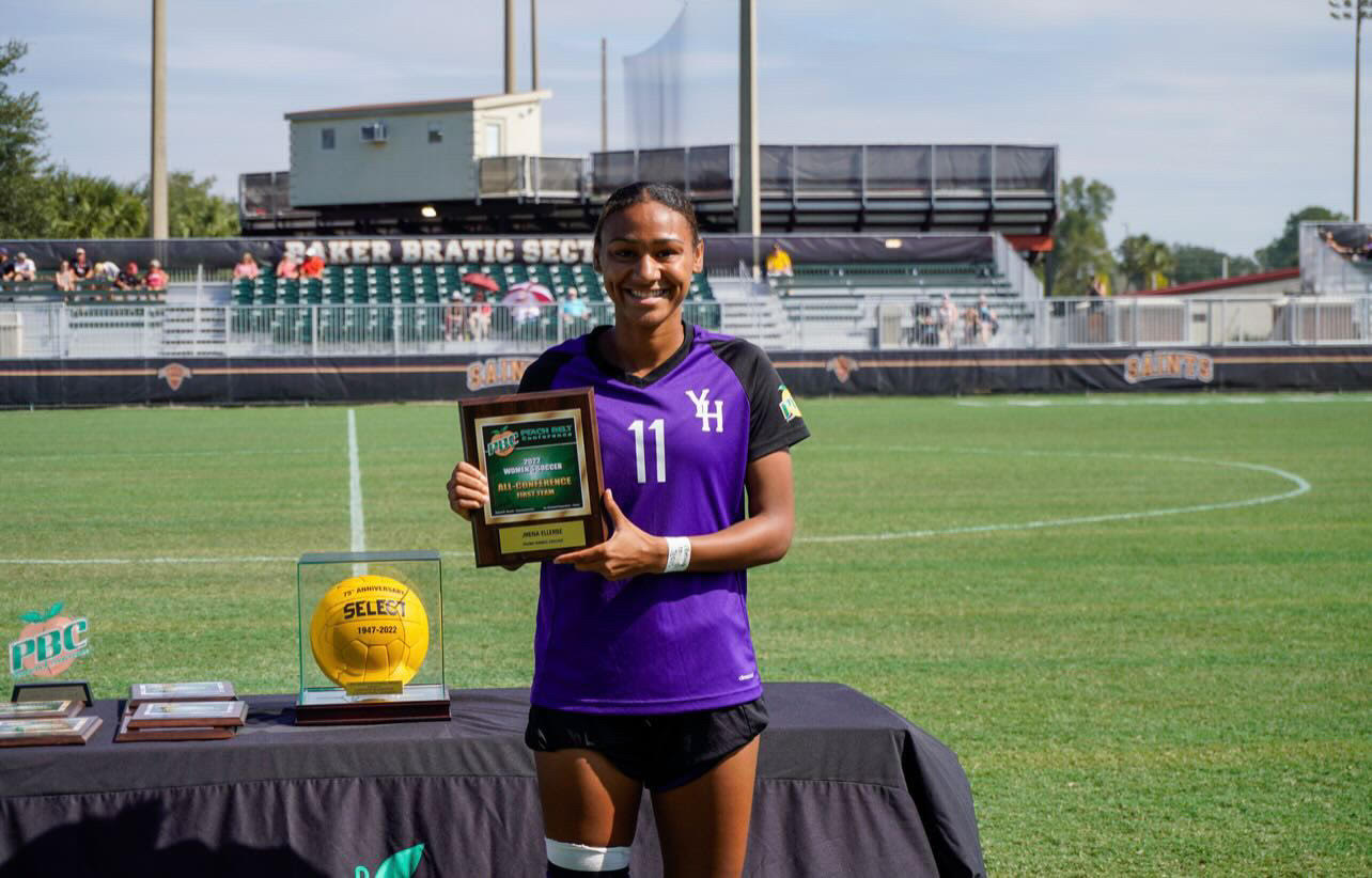 Jhenesis Ellerbe holding a trophy